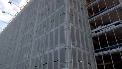 panning shot of multiple storey airport car park building from the outside
