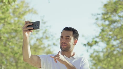 handsome young man having video call through phone.