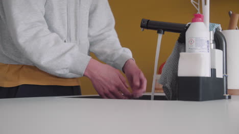 male washing hands in a modern kitchen