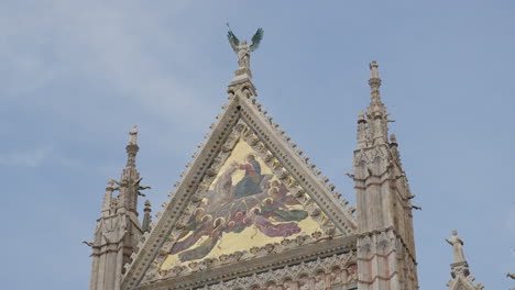 historic siena cathedral peak with angel statue and mosaic