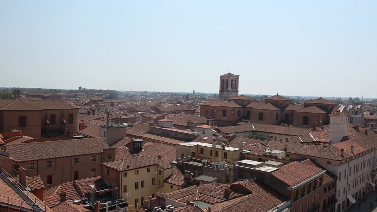 Panorama from Estense Castle viewpoint over Ferrara old town, buildings roofs in sunlight