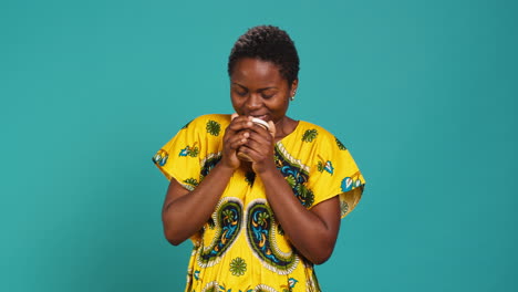 Woman-in-traditional-ethnic-clothing-drinks-a-sip-from-coffee-cup