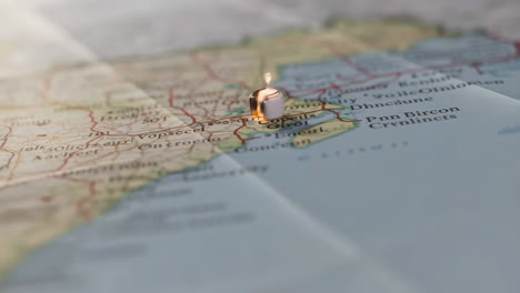 a candle marking a location on a map