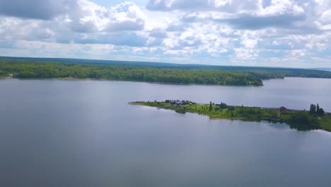 aerial view of a lake with an island and houses