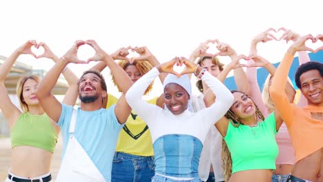 diverse group of people making heart shapes with their hands