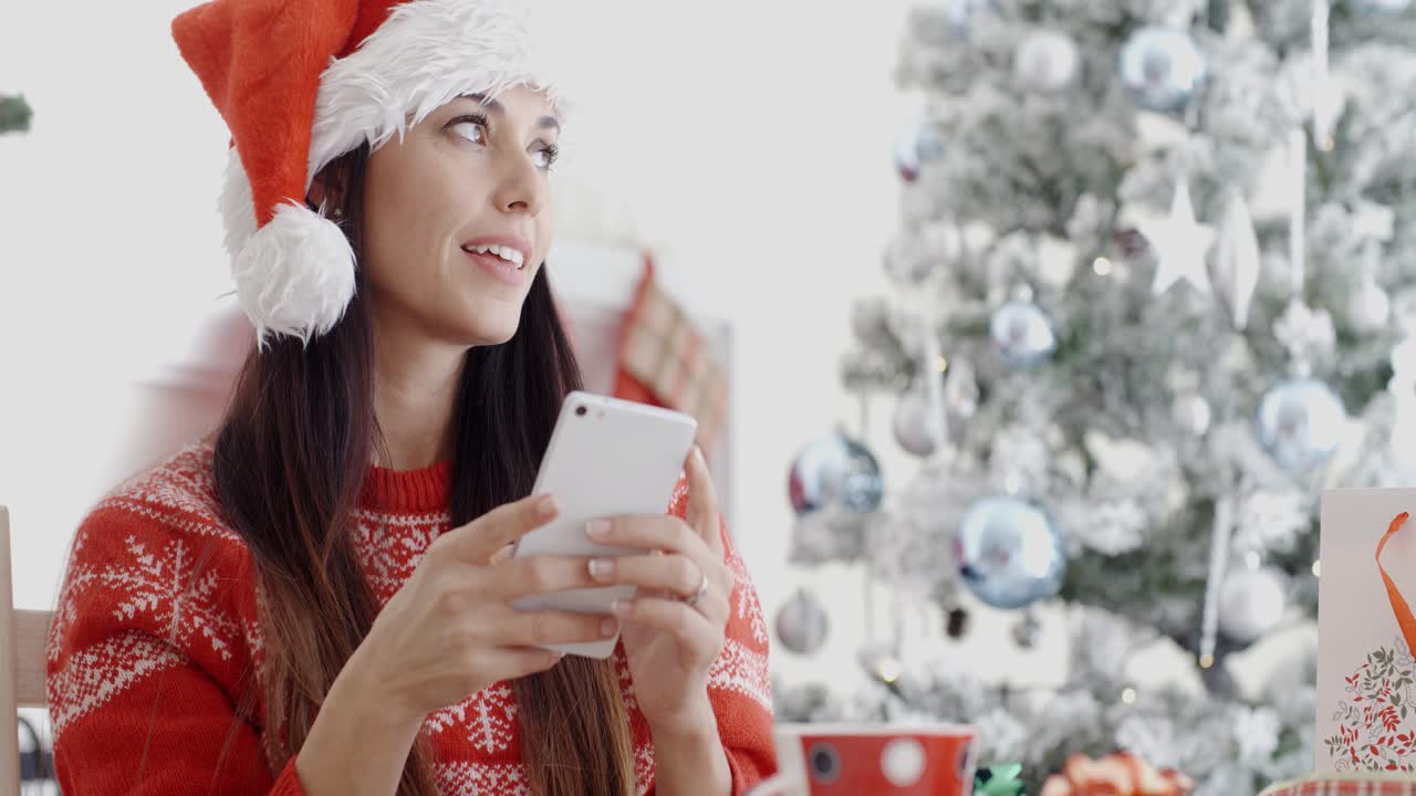 mujer atractiva comprobando los mensajes de navidad
