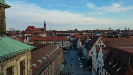 4k aerial drone video of copper-clad cupolas on rooftops around hauptmarkt market square in nürnberg, germany