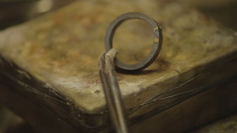 italian goldsmith at work building an engagement or a wedding ring