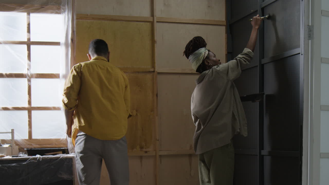 People painting interior of house