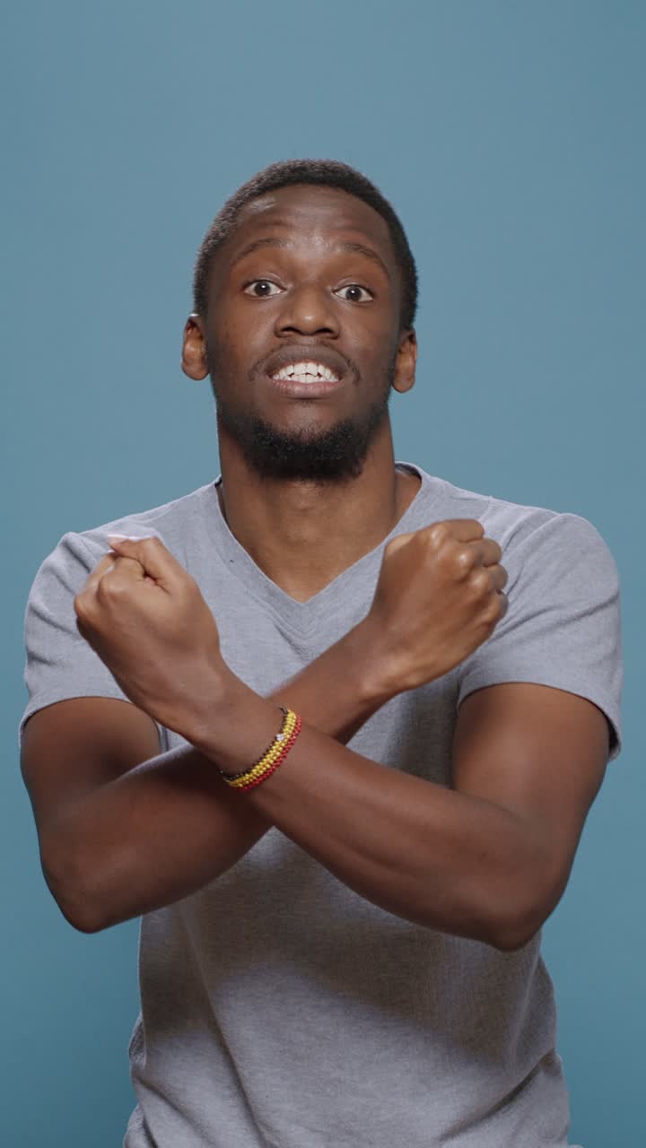 Man Crossing Arms in Fear