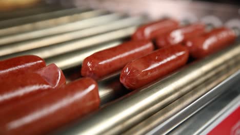 hot dogs on a conveyor belt