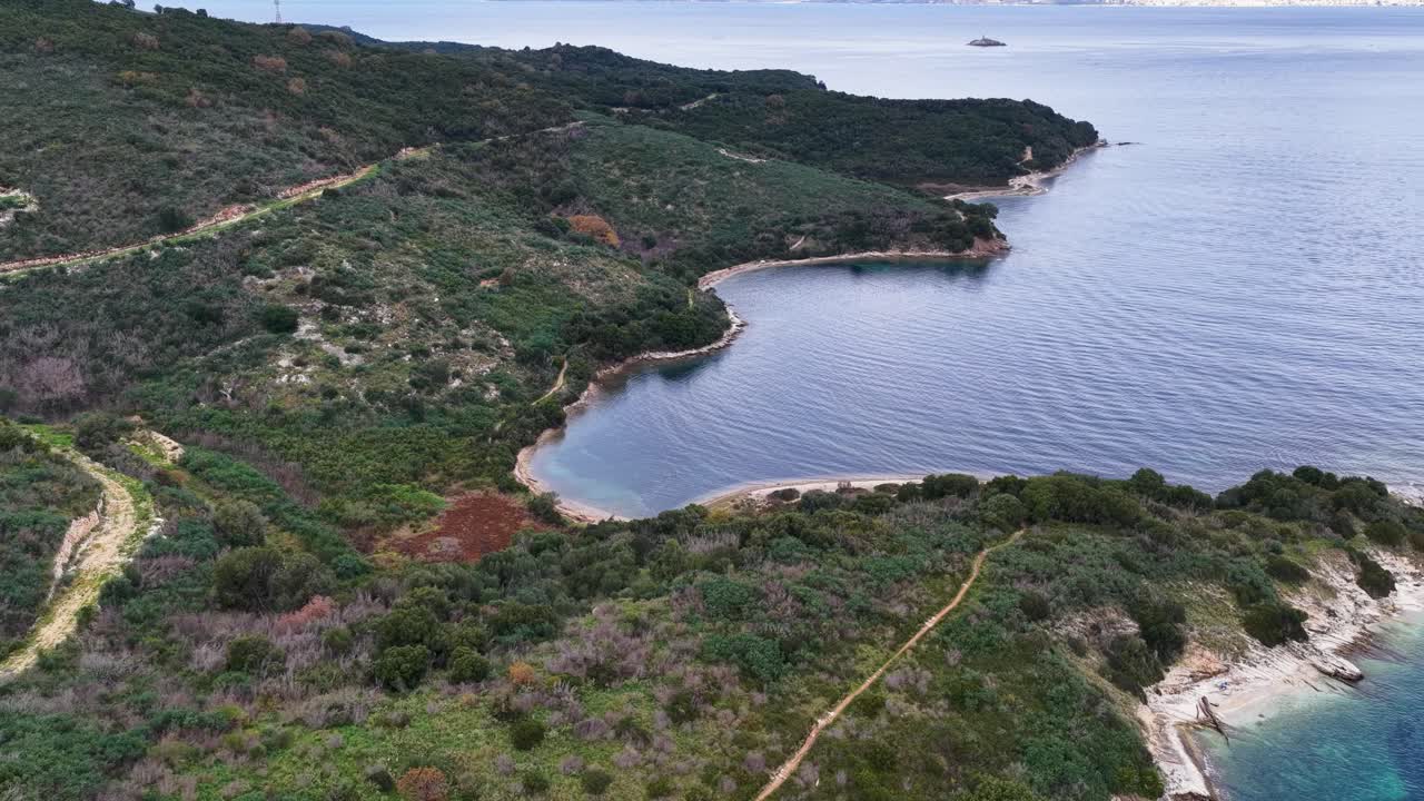 Aerial view of secluded pristine beach cove with crystal clear water in Corfu Greece nature