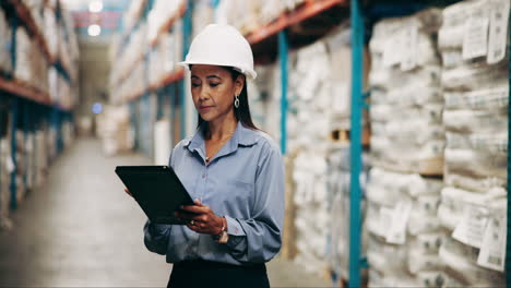 a warehouse worker checking inventory on a tablet