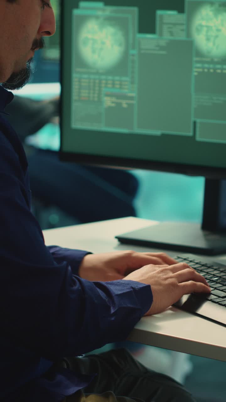 Focused Programmer Typing Code on Computer in Office