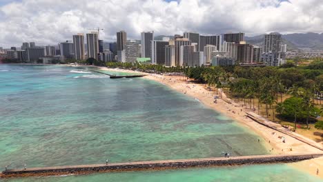 sunny day at waikiki beach with city development and crane