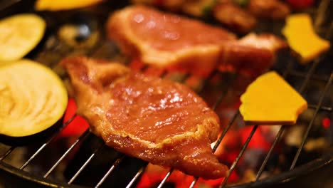 sizzling steak and veggies on a charcoal grill