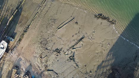 View of riverbank with small boats and lots of litter and garbage