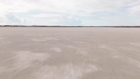 aerial view of a vast saltwater lagoon in sardinia, italy. surrounded by wild nature, this serene wetland is a haven for birdwatching and natural beauty, ideal for nature footage.