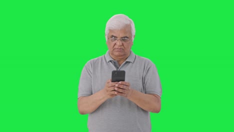 Angry-Indian-old-man-chatting-with-someone-Green-screen