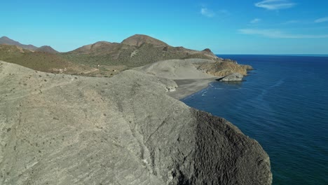 Rocky-Cliffs-and-Monsul-Beach-at-Cabo-de-Gata,-Almeria,-Andalusia,-Spain---Aerial-4k