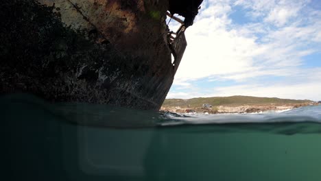 close up of meisho maru shipwreck hull at cape agulhas southernmost tip of south africa, low water surface shot