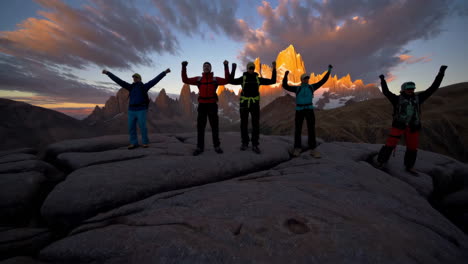 climbers celebrating a summit at sunrise in the fitz roy mountains