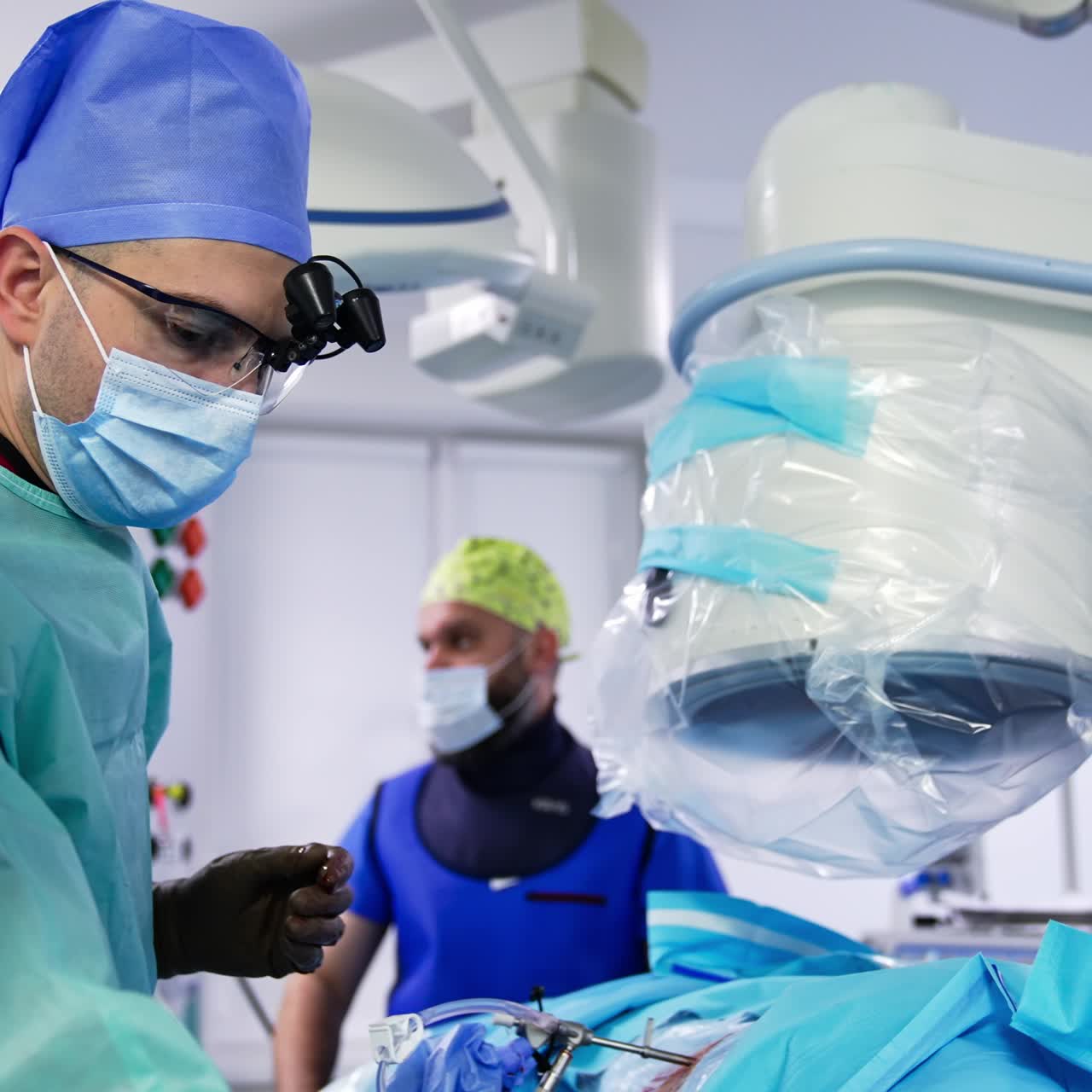 Handsome neurosurgeon working in modern hospital. Doctor neurosurgery operating in emergency ward