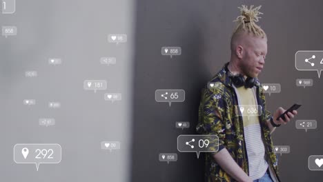 animation of social media icons against african american albino man using smartphone