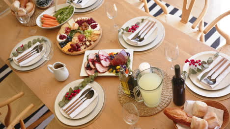 high angle of food on dinner table set for christmas meal, slow motion