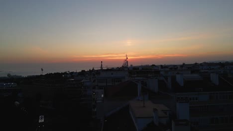 twilight hues over lisbon skyline. aerial ascend