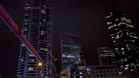 Panning-shot-showing-lighting-skyscraper-buildings-in-Frankfurt-at-night,-Germany