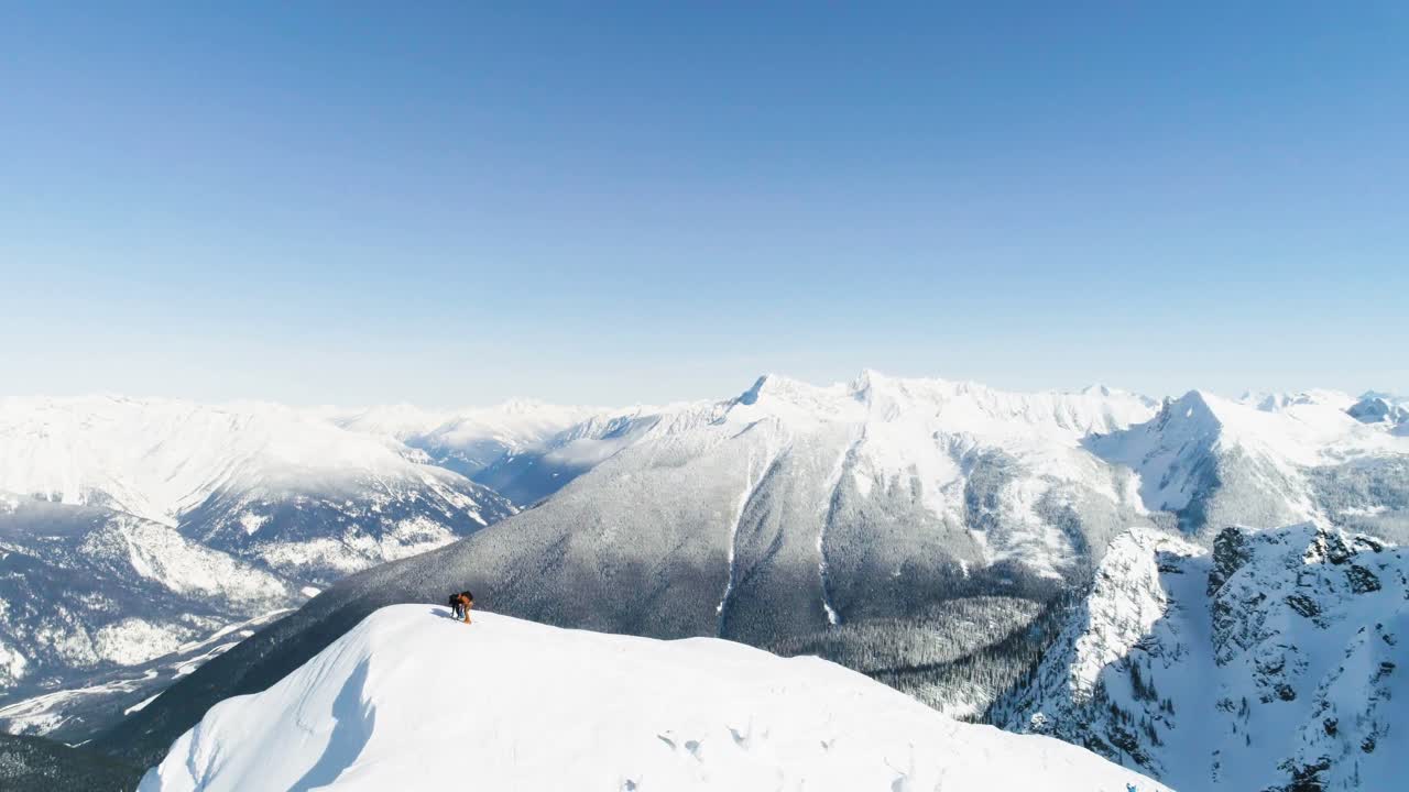 esquiadores de pie en una montaña cubierta de nieve 4k