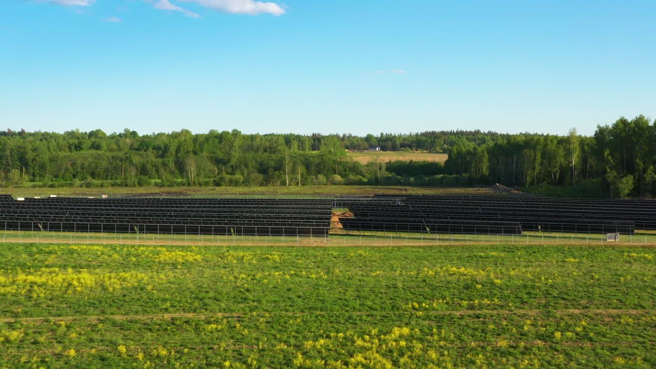 Extensive Solar Panel Farm on Green Field in Aerial Approaching view