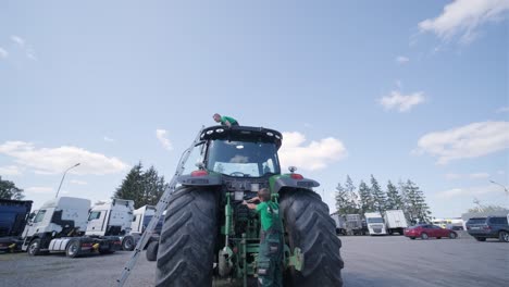 farmer mechanic repairing tractor. open tractor hood, engine. repair agricultural technology