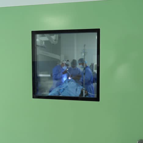 group of doctors perform an operation to a patient. surgeons in medical uniform and masks working in the operating room