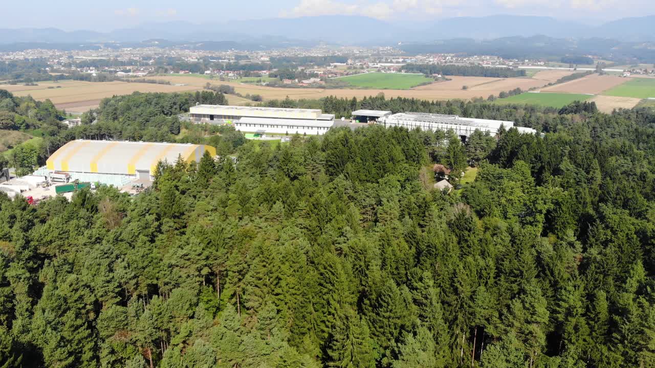 Plastic recycling plant near a forest area in eastern Europe, Aerial approach shot