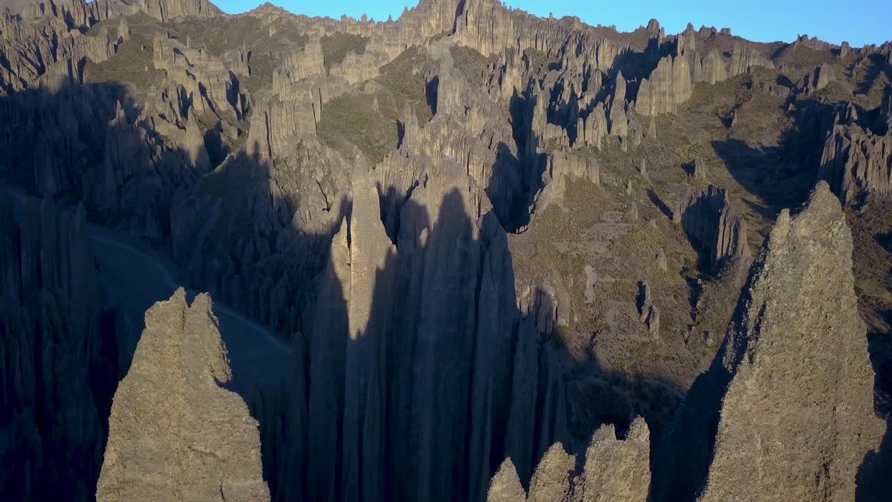 Scenic aerial view flying over Valle de las &Aacute;nimas, La Paz, Bolivia, lit by the early morning sun