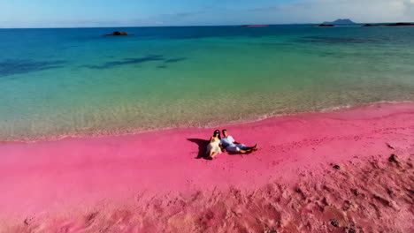 couple relaxing on the iconic pink beach of komodo national park