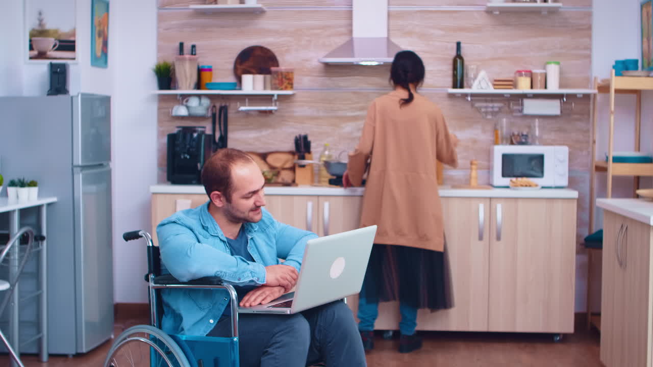 Disabled man waving on video conference