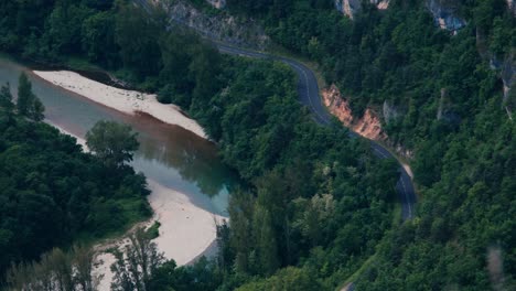 a winding river snakes through a dense forest with pristine curves.