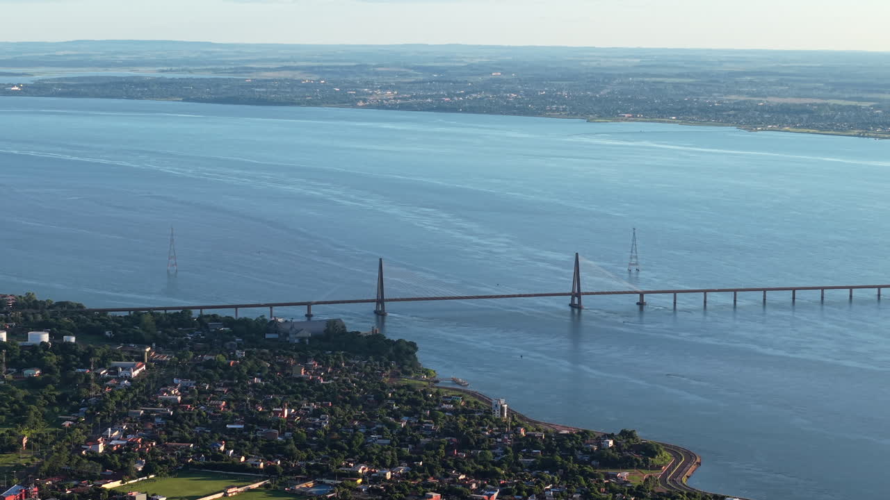 Aerial landscape fly above San Roque González de Santa Cruz Bridge landscape, cable stayed across Paraná River, Posadas and Encarnación, Paraguay