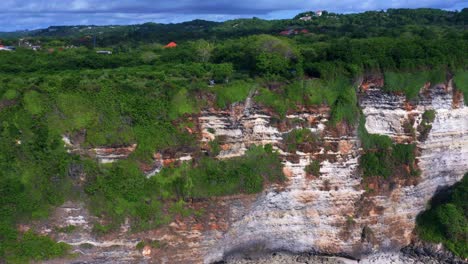 uluwatu ocean cliff in bali, indonesia - drone pullback