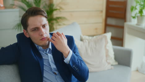 Self-Confident-Businessman-Thinks-on-Sofa