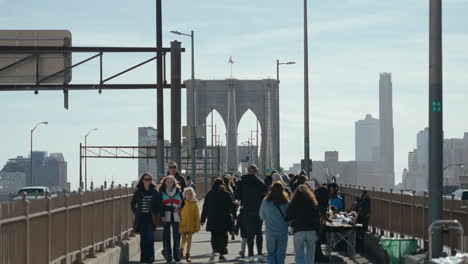 people walking on the brooklyn bridge