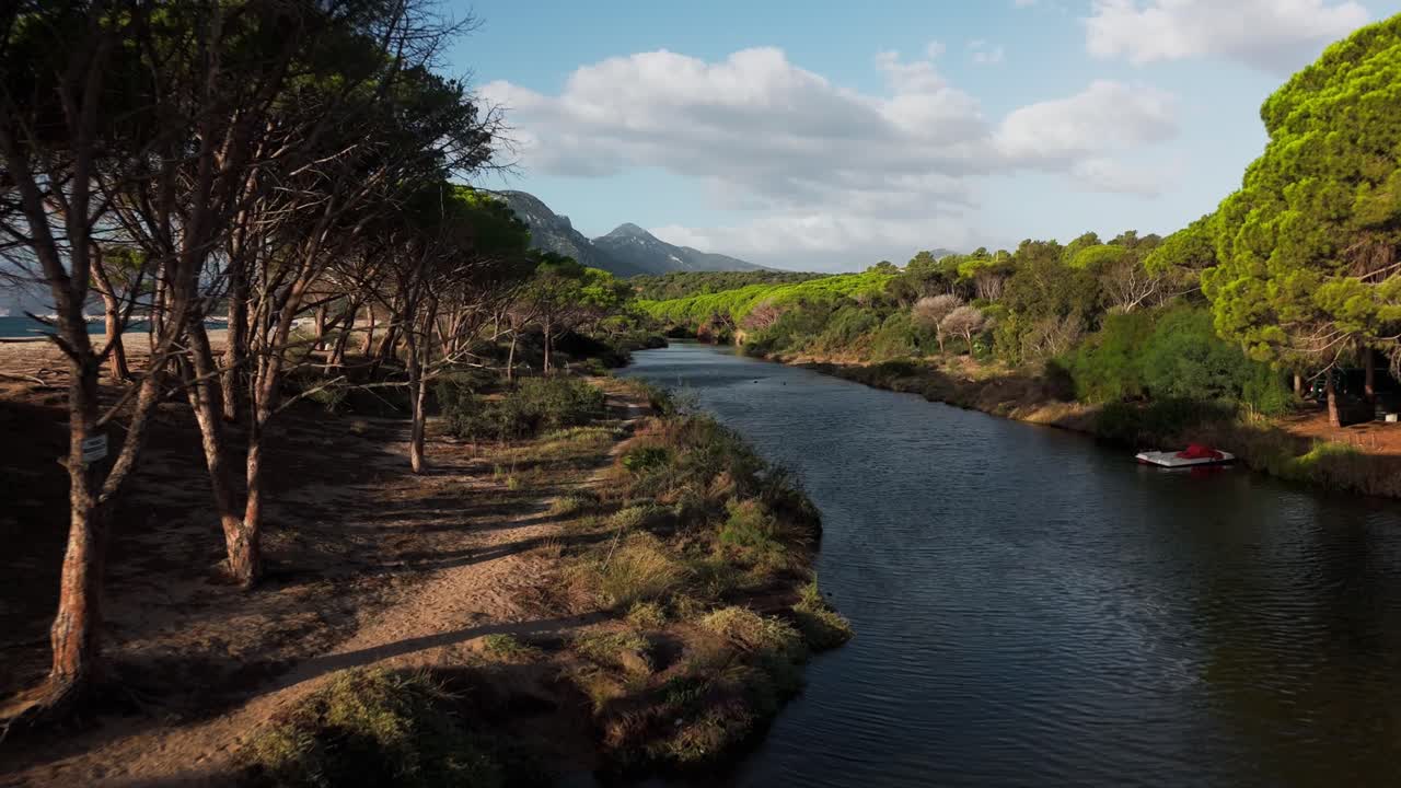 Idyllic sandy beach is adjacent to a meandering river. This serene landscape combines the tranquility of the beach with the peaceful flow of the river, perfect spot for relaxation and exploration.