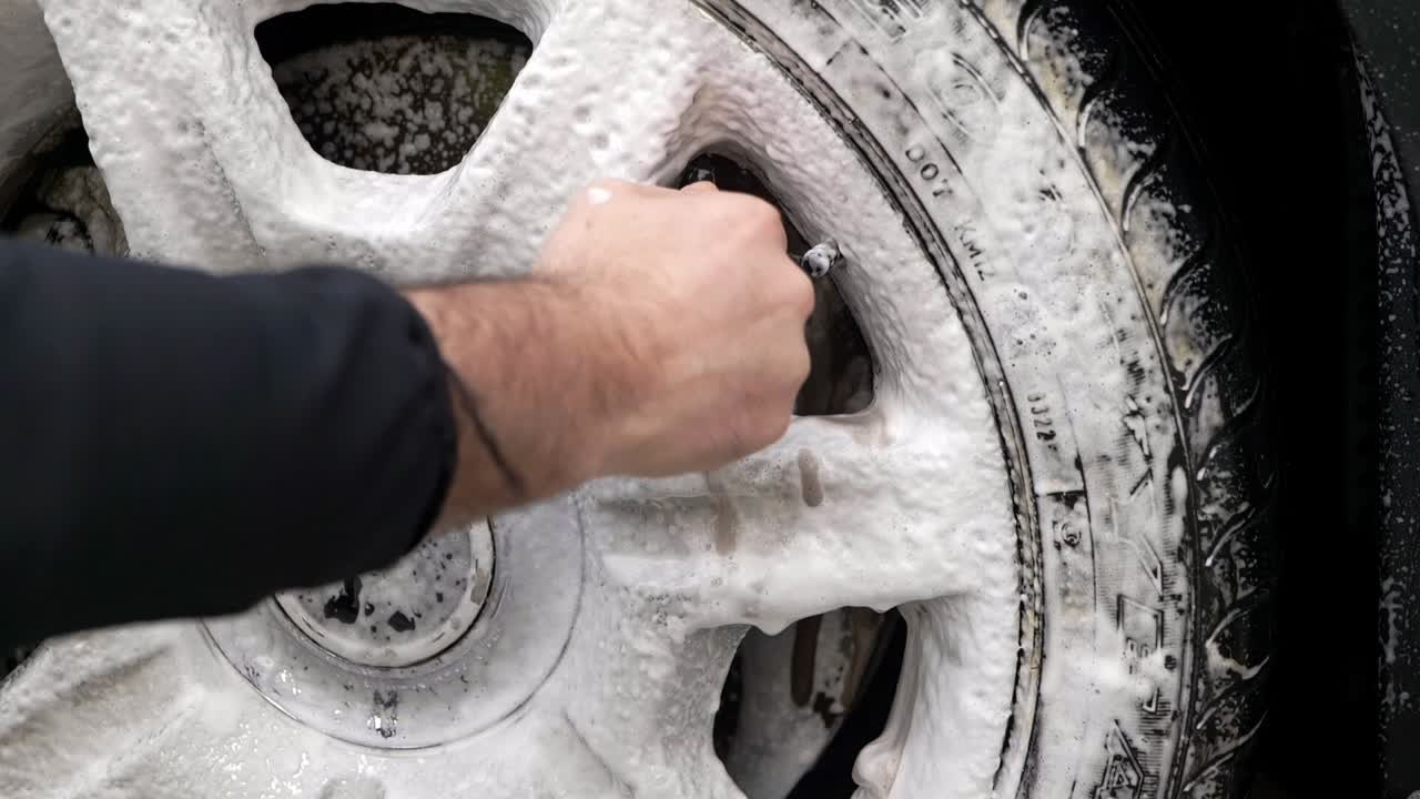 Cleaning a large chrome alloy wheel with snow foam and microfibre wheel brush