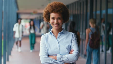 Portrait-Of-Smiling-Female-High-School-Or-Secondary-Teacher-Outdoors-At-School