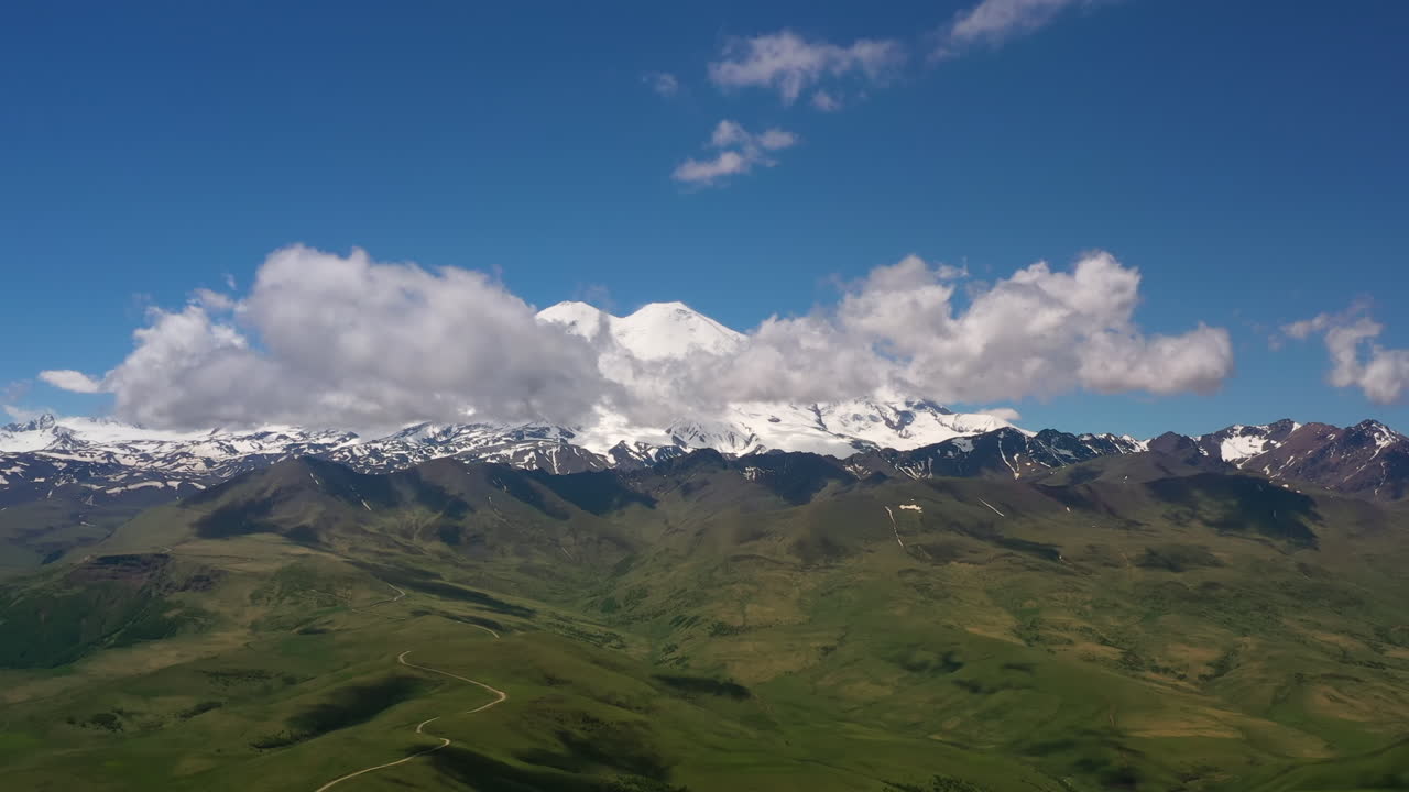 Elbrus Region. Flying over a highland plateau. Beautiful landscape of nature. Mount Elbrus is visible in the background.