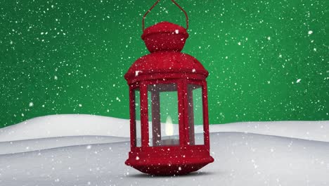 animación digital de la nieve cayendo sobre la linterna de navidad en la nieve contra un fondo verde