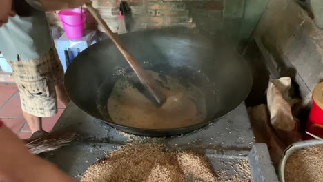 a large cooking pot for mixing malt with malt grains in the background